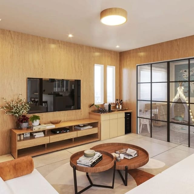 Sala integrada com painel de madeira e divisória de vidro